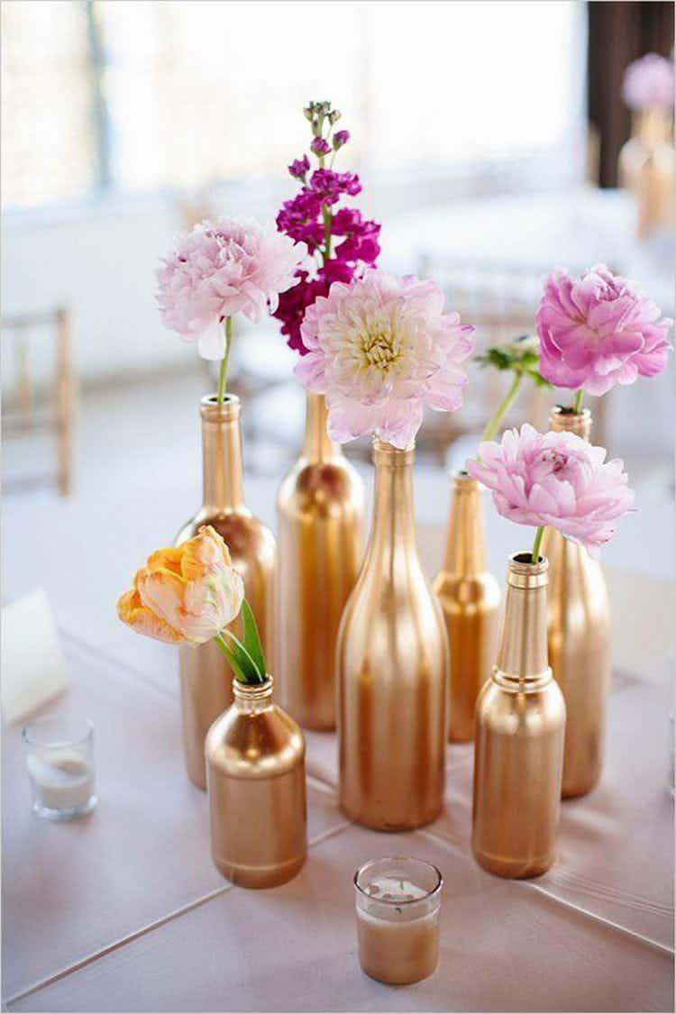 Spray-paint old mason jars, bottles, and vases and use them as flower holders.