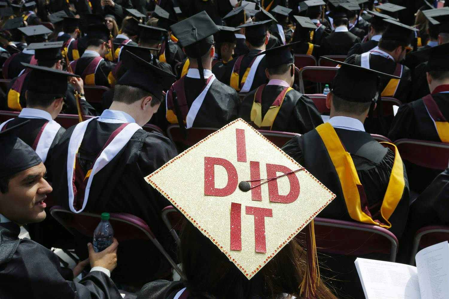 Crowd of new graduates one hat reads, "I did it