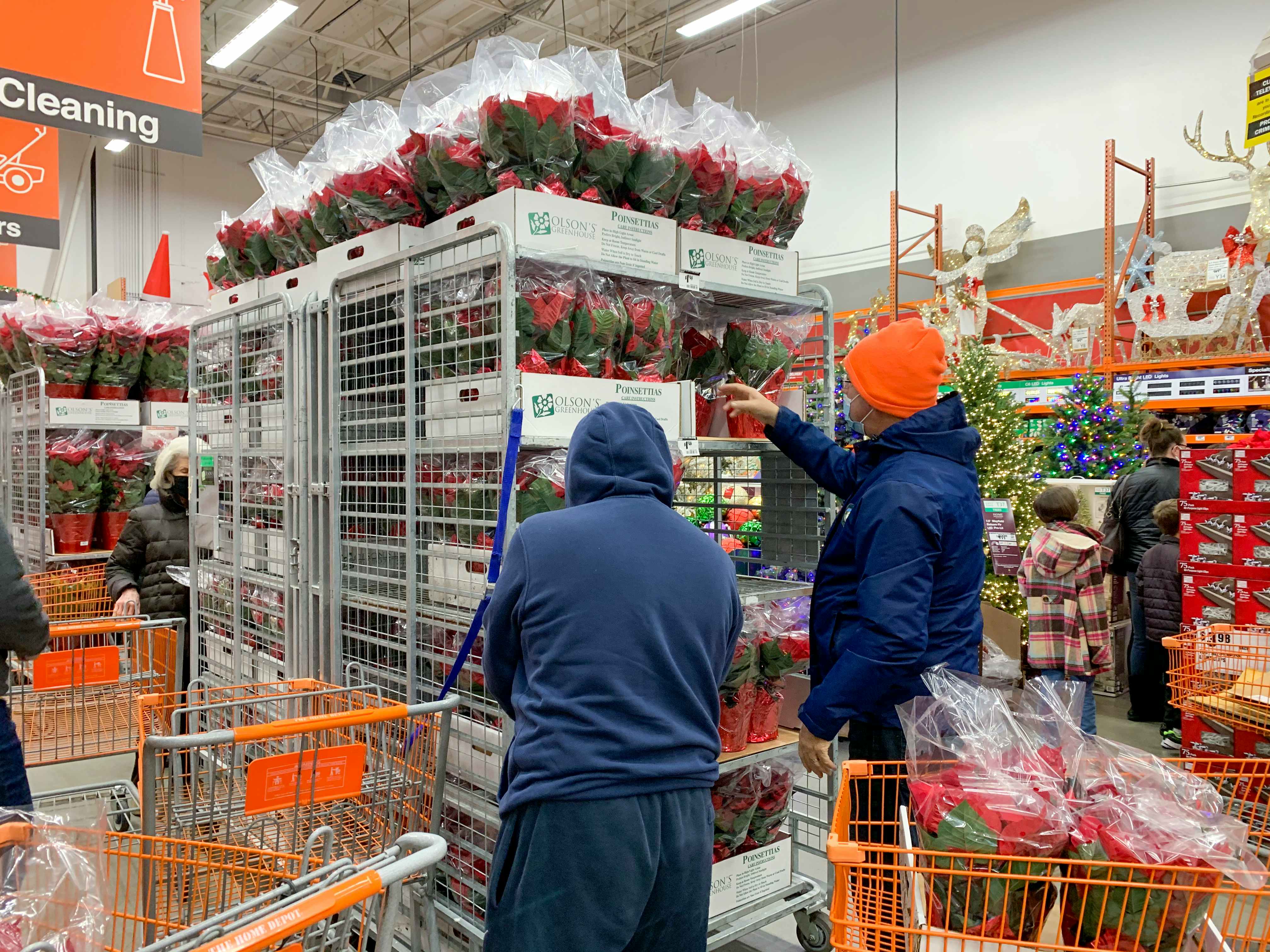 People shopping for Poinsettias at the Home Depot black Friday sale.