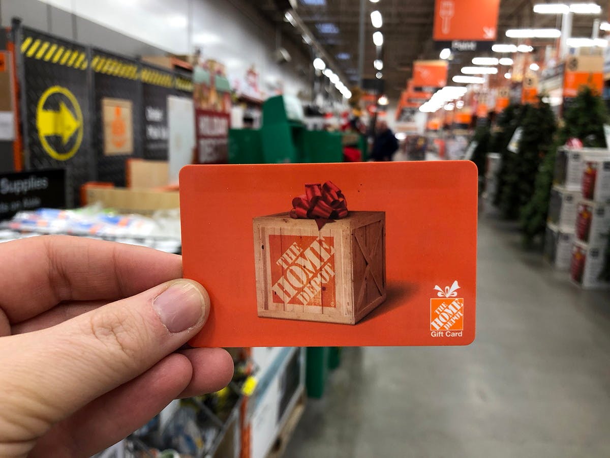 someone holding a home depot gift card at home depot