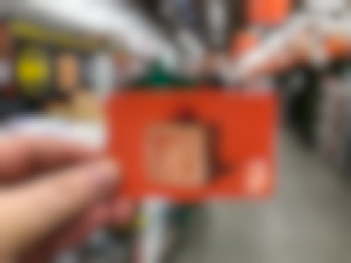 someone holding a home depot gift card at home depot