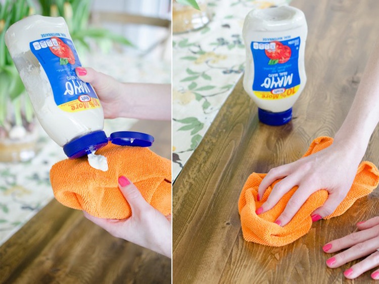 a person cleaning a table with mayo