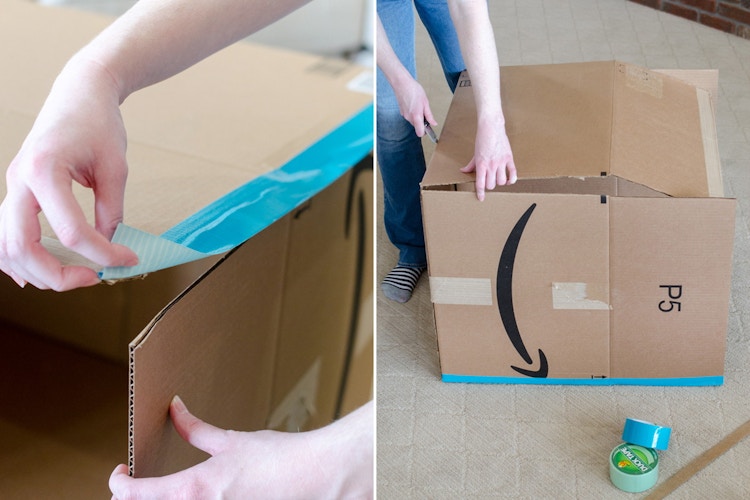A person taping up cardboard boxes.