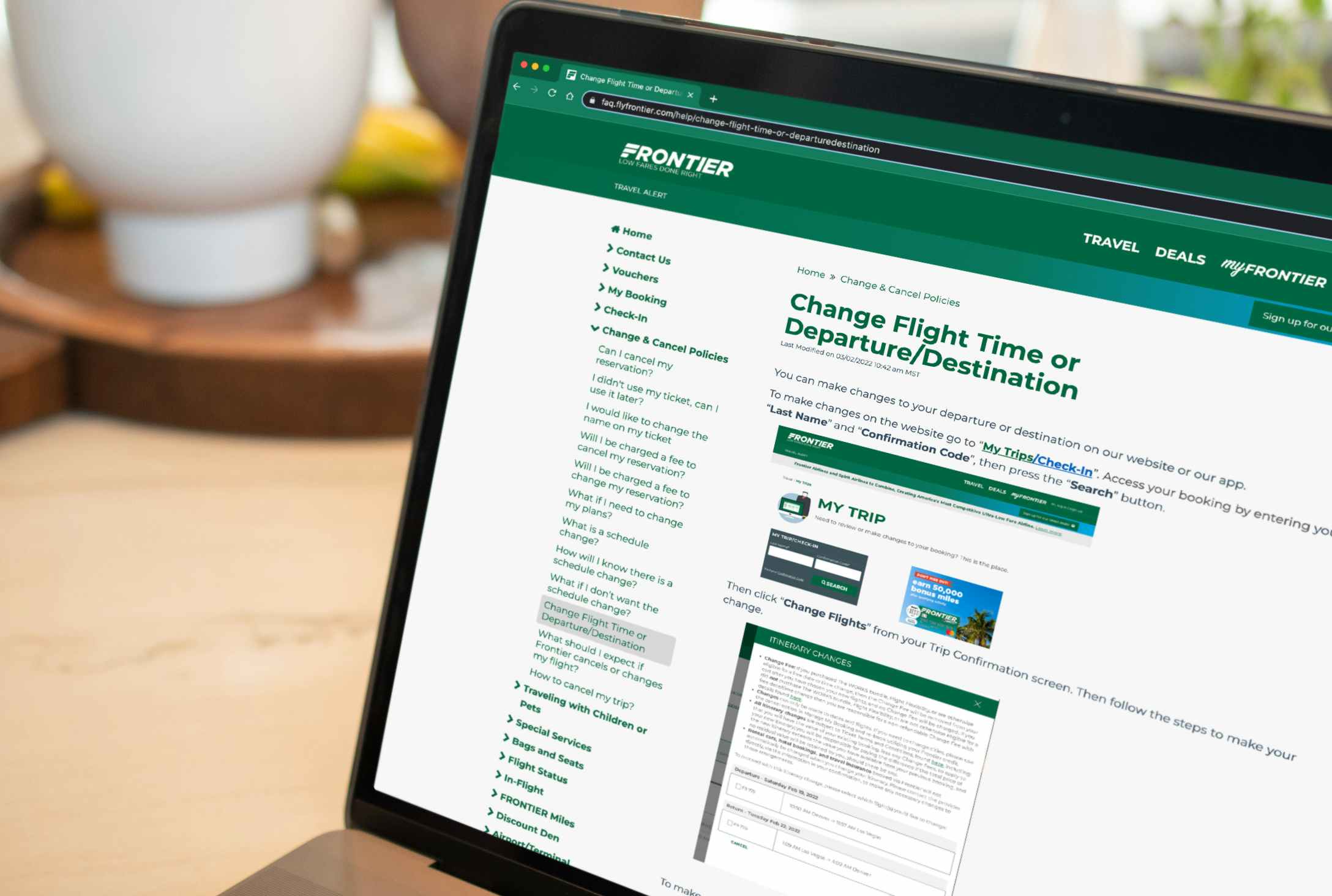 frontier airlines website showing itinerary change on laptop