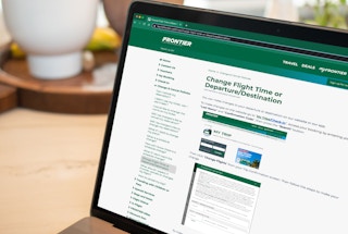 frontier airlines website showing itinerary change on laptop