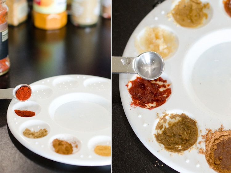 a person putting spices into a plastic paint pallet