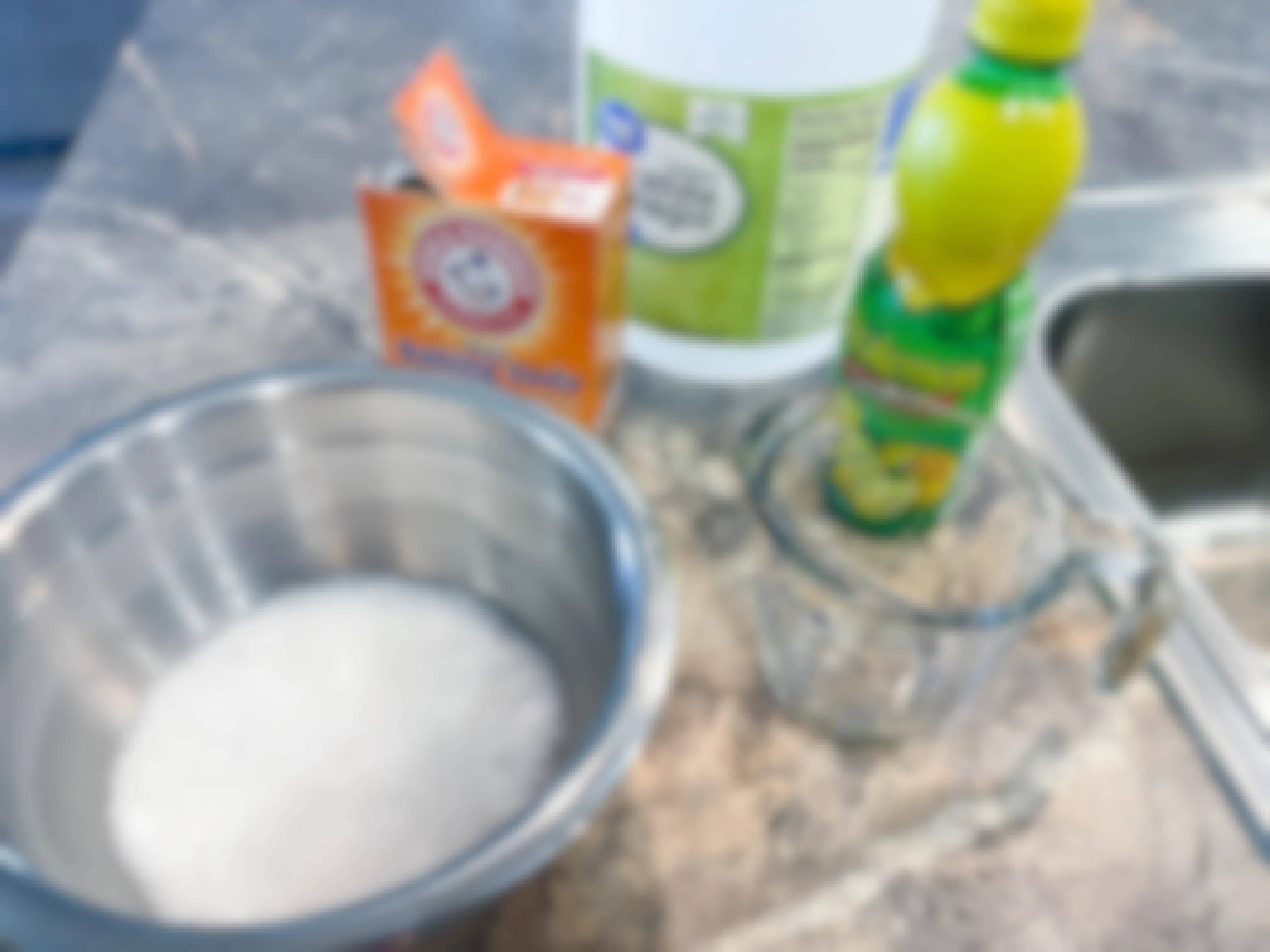 bowl with baking soda, vinegar, and lemon juice on counter