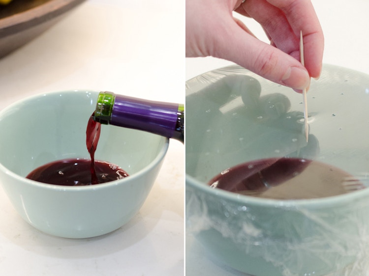 a person putting stale wine into a bowl to catch fruit flies