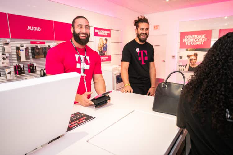 Two male employees at the T-Mobile store.
