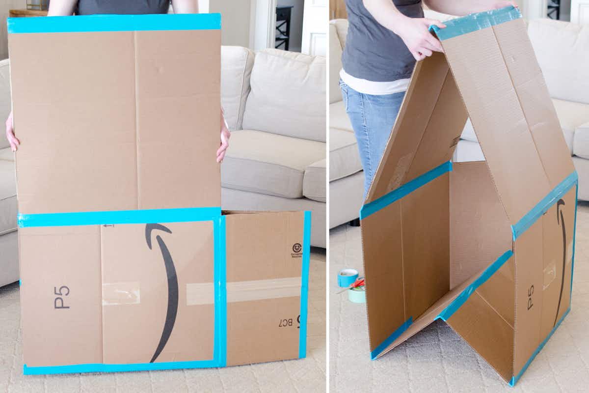 A person taping cardboard boxes together to form a playhouse.