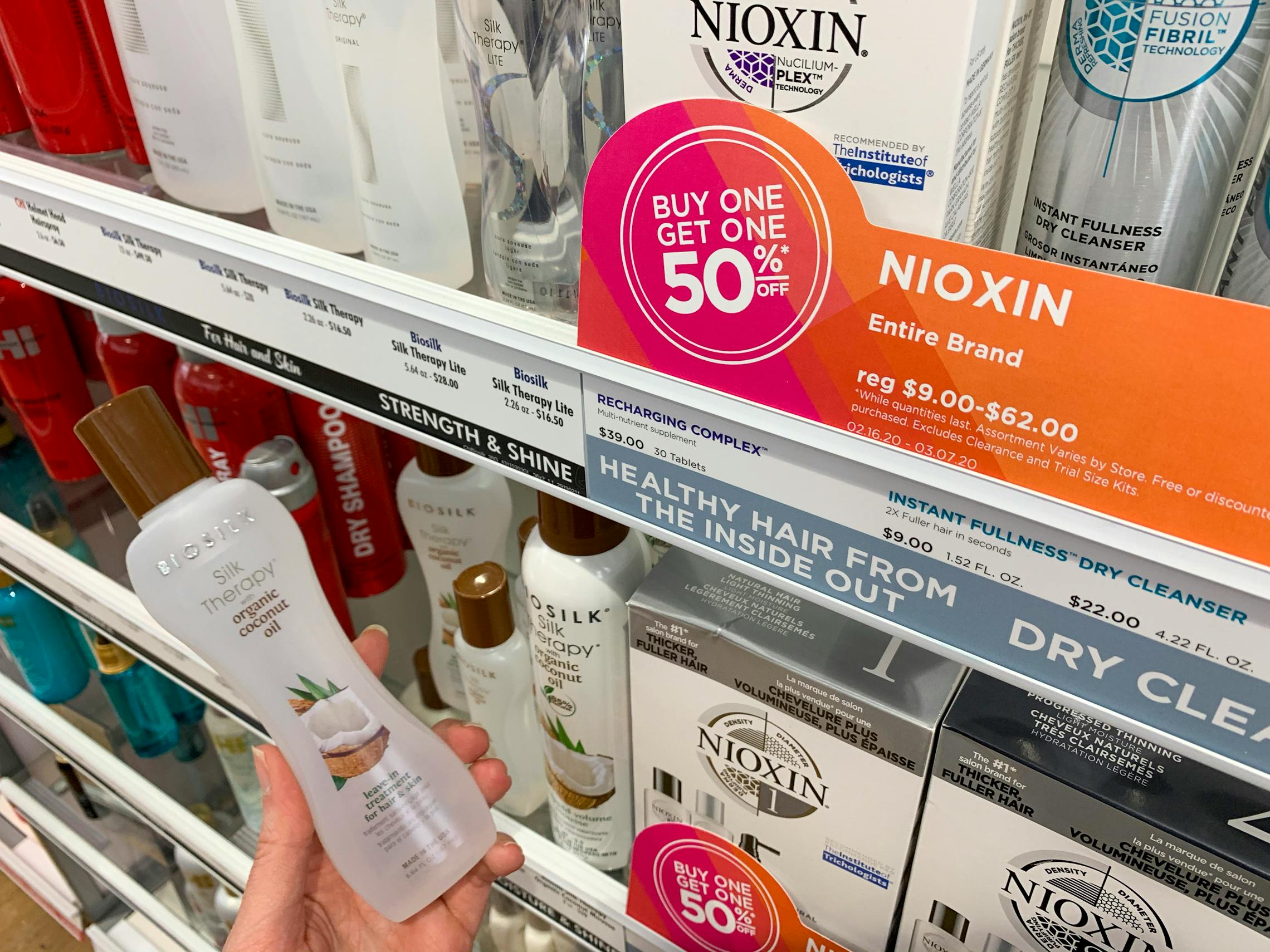 A buy one, get one fifty percent off Nixon hair care sign and products.