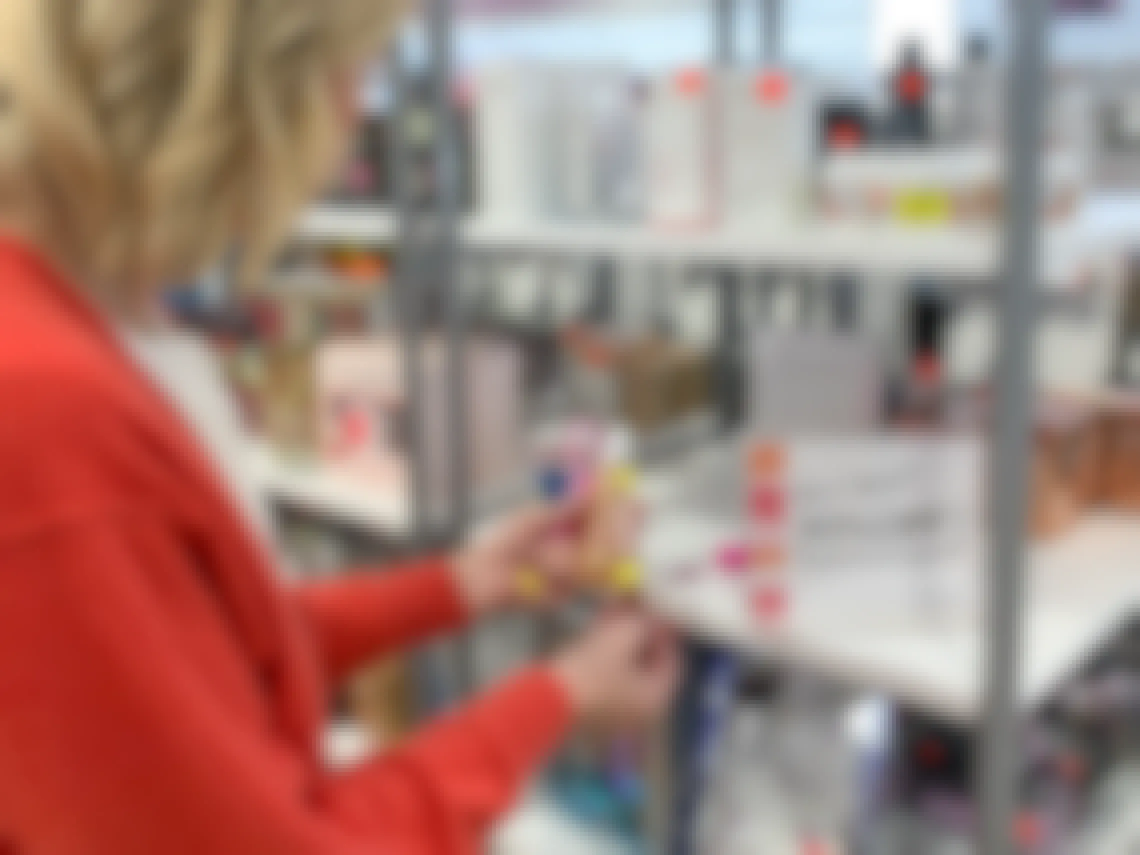 A woman looking at items on the clearance shelf in Ulta.