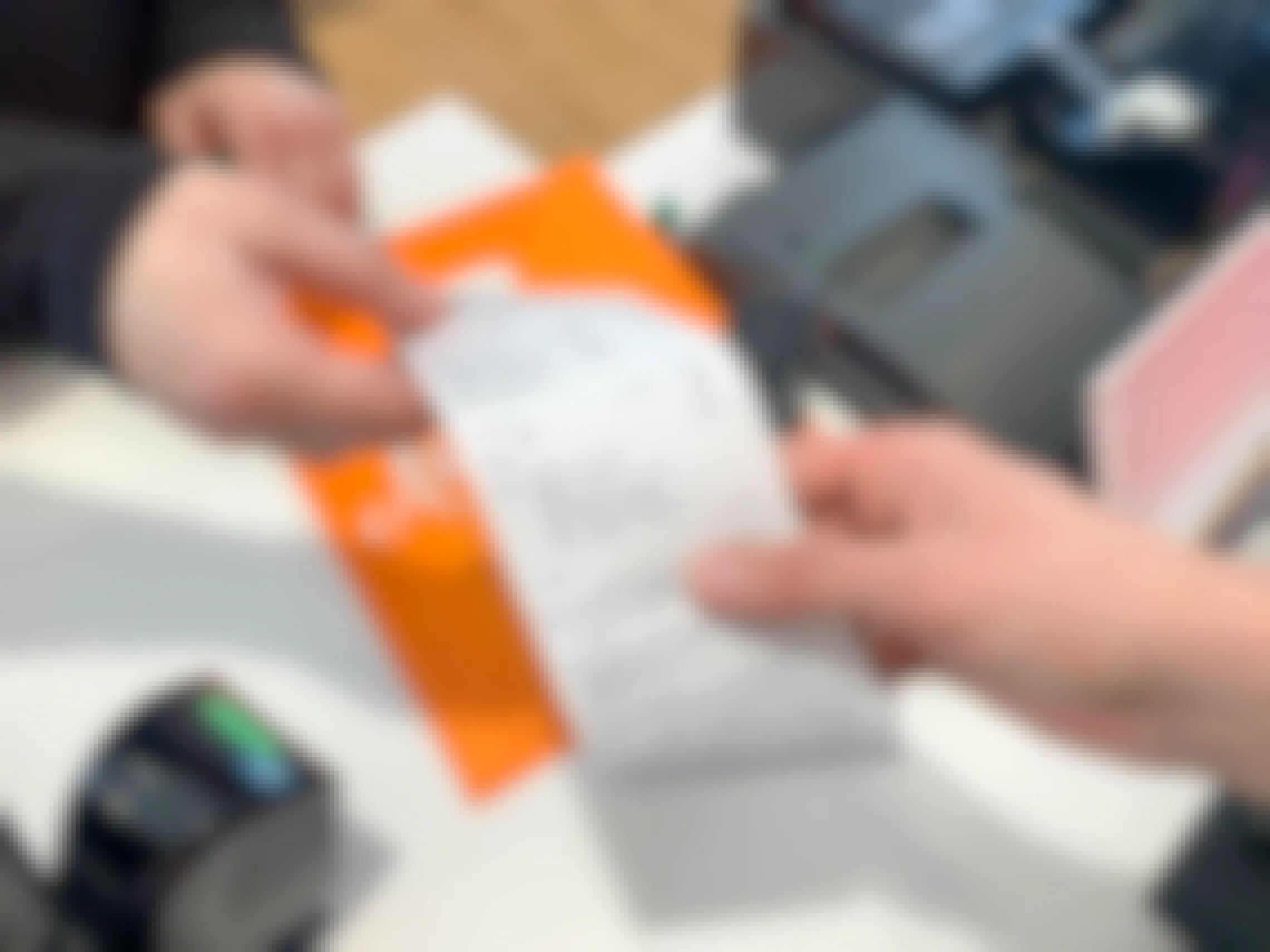 An Ulta employee handing a receipt to a customer at checkout in the Ulta store
