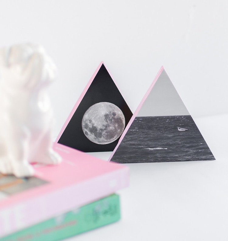 Glue photos onto painted triangle wood blocks.