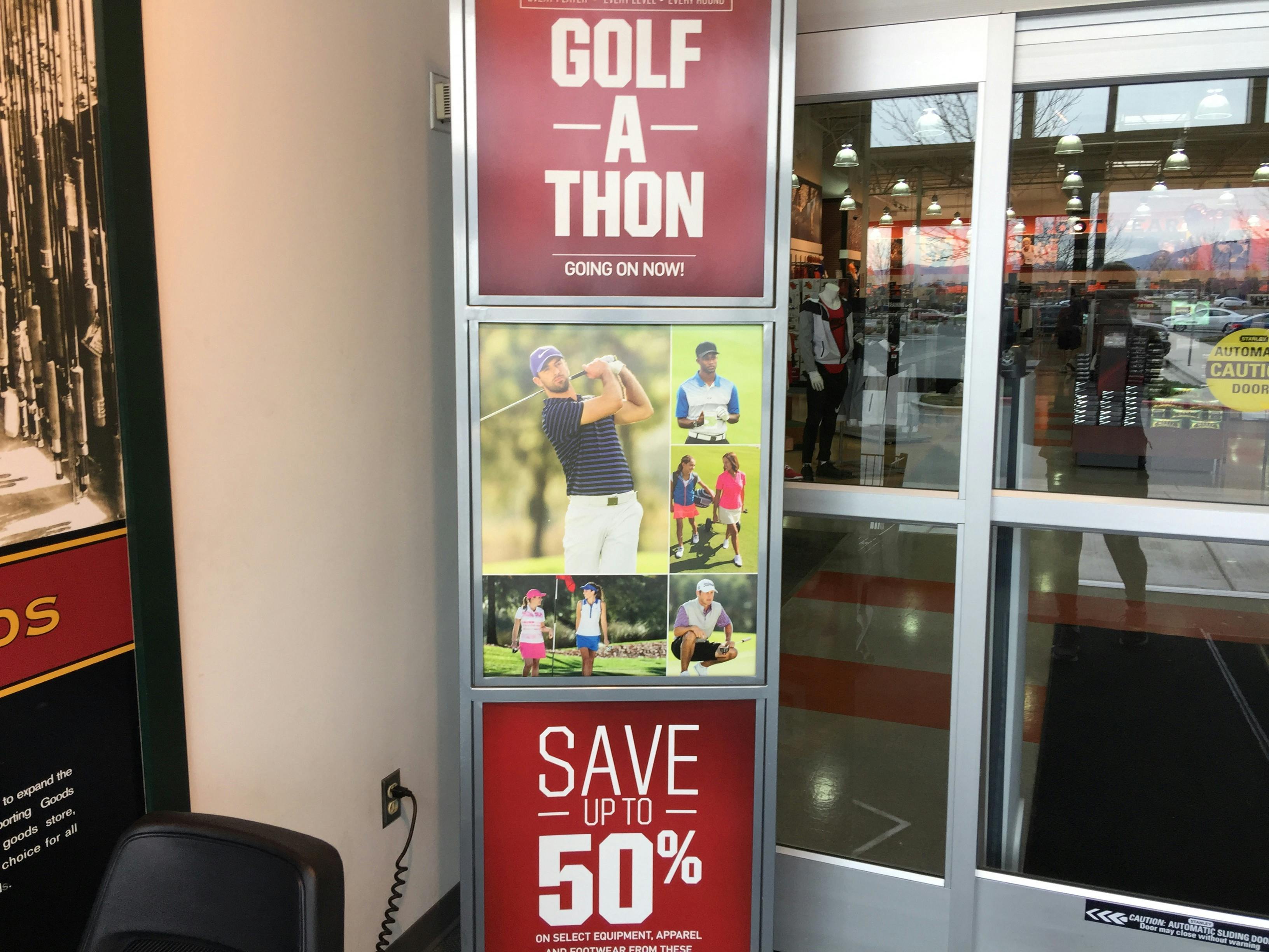 A large sign at the entrance of a Dick's Sporting Goods, advertising the Golf-A-Thon sale.