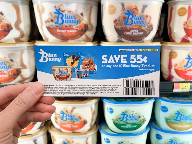 Blue Bunny Ice Cream coupon held in front of ice cream cooler in store.