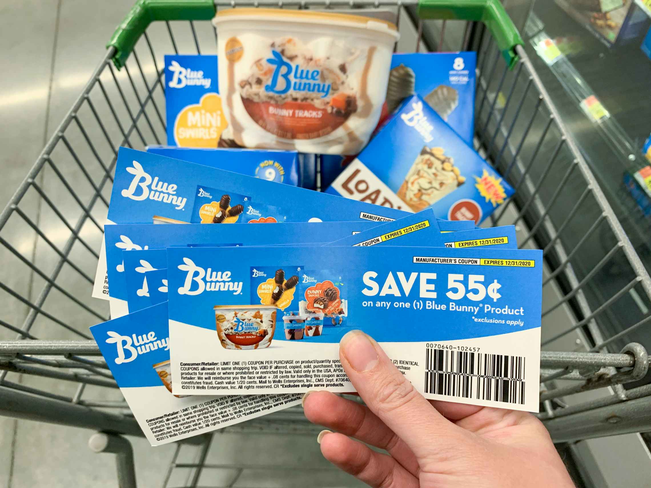 Blue Bunny Ice Cream coupons held in front of basket of ice cream treats.