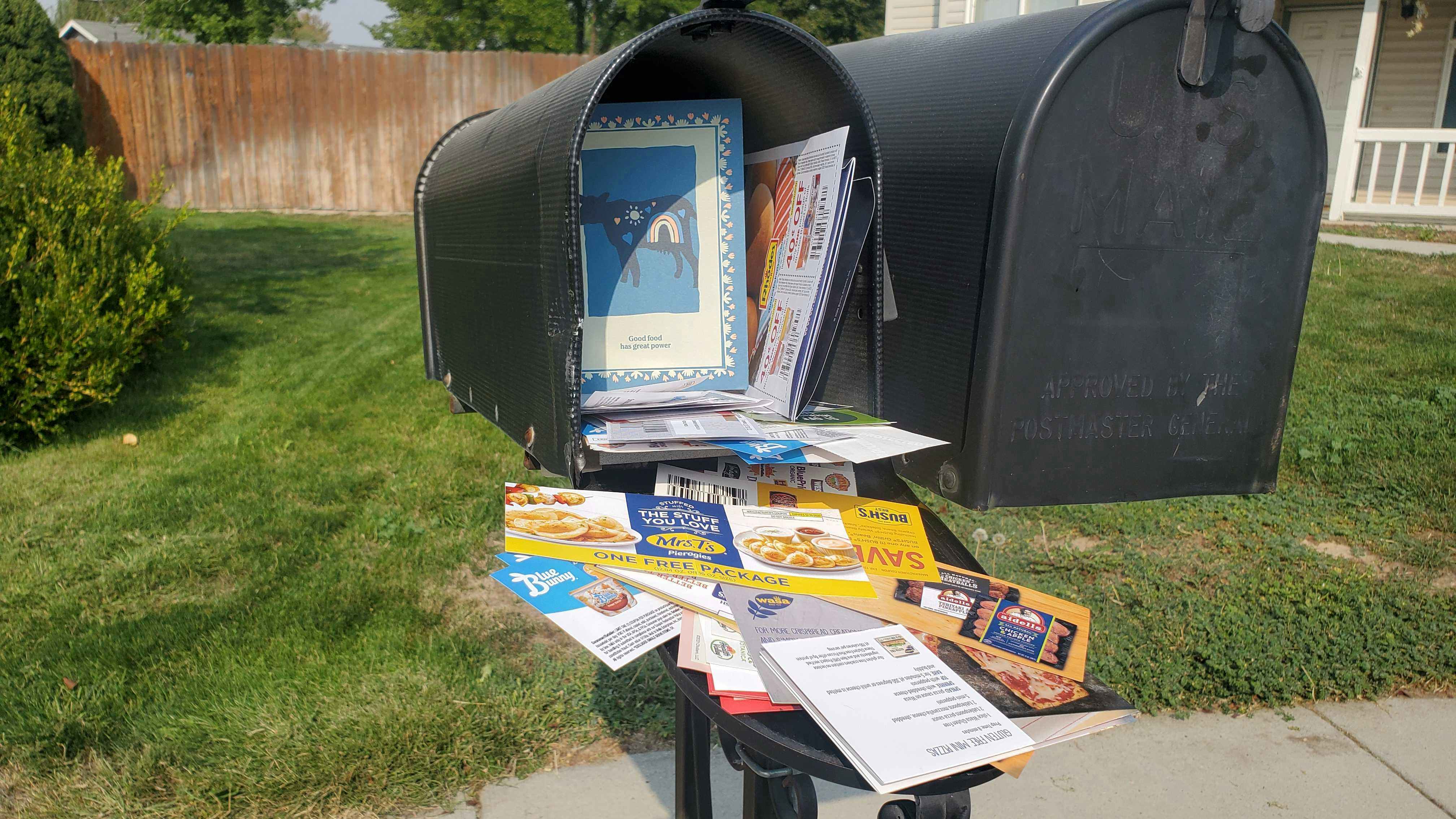 Mailbox overstuffed with coupons