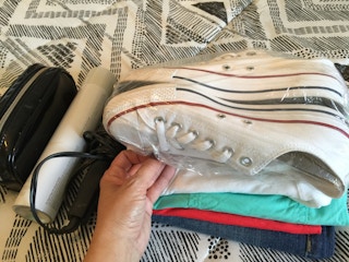Two shoes with shower cap over them.