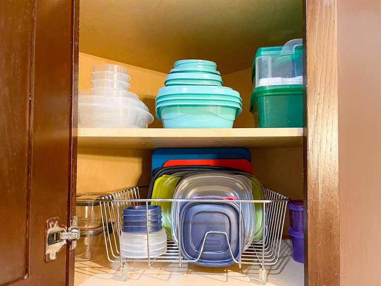 tupperware organized with dish racks in cabinet