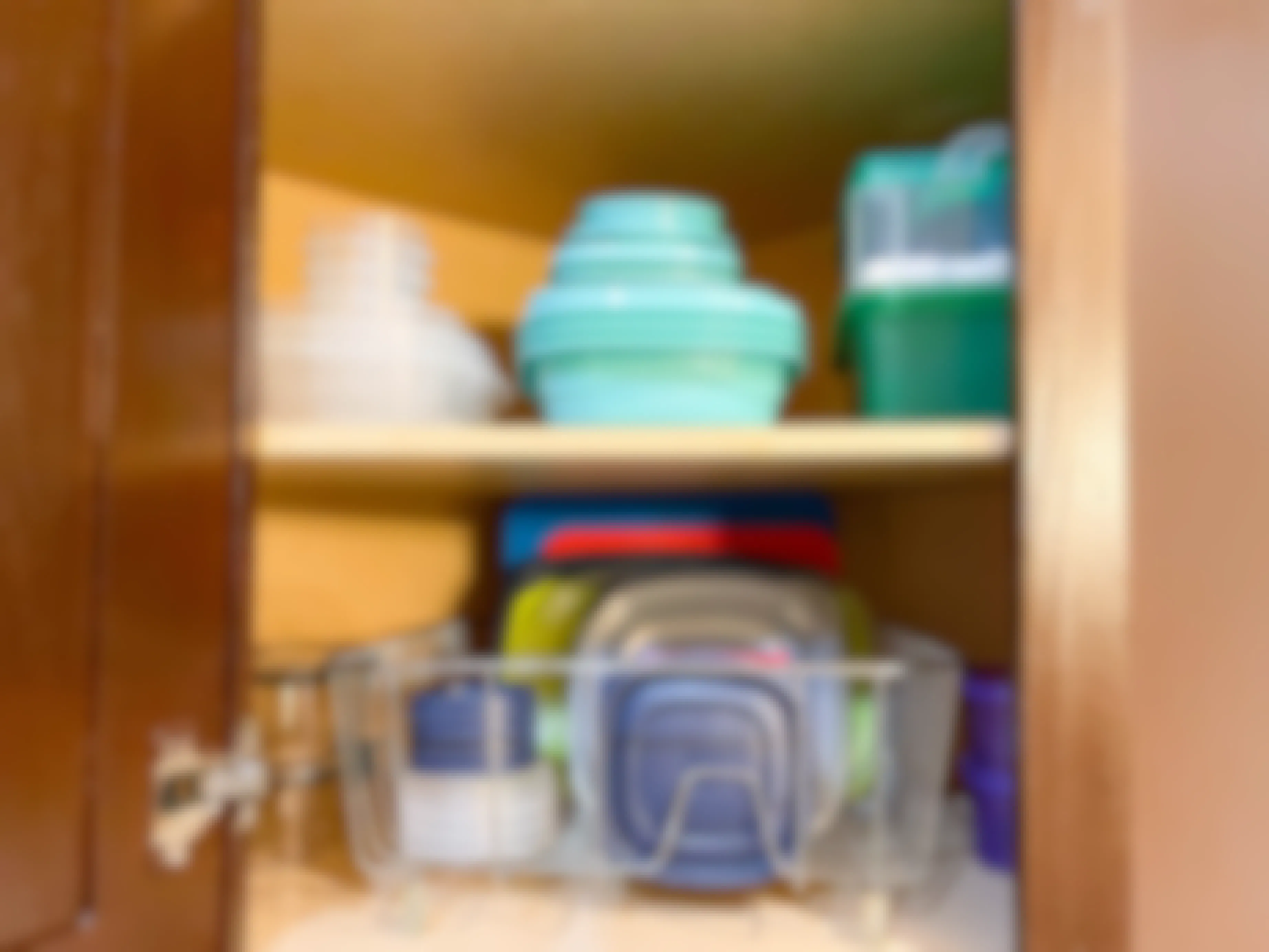 tupperware organized with dish racks in cabinet