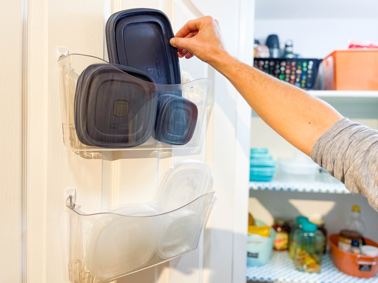 tupperware organized on door on wall file folders