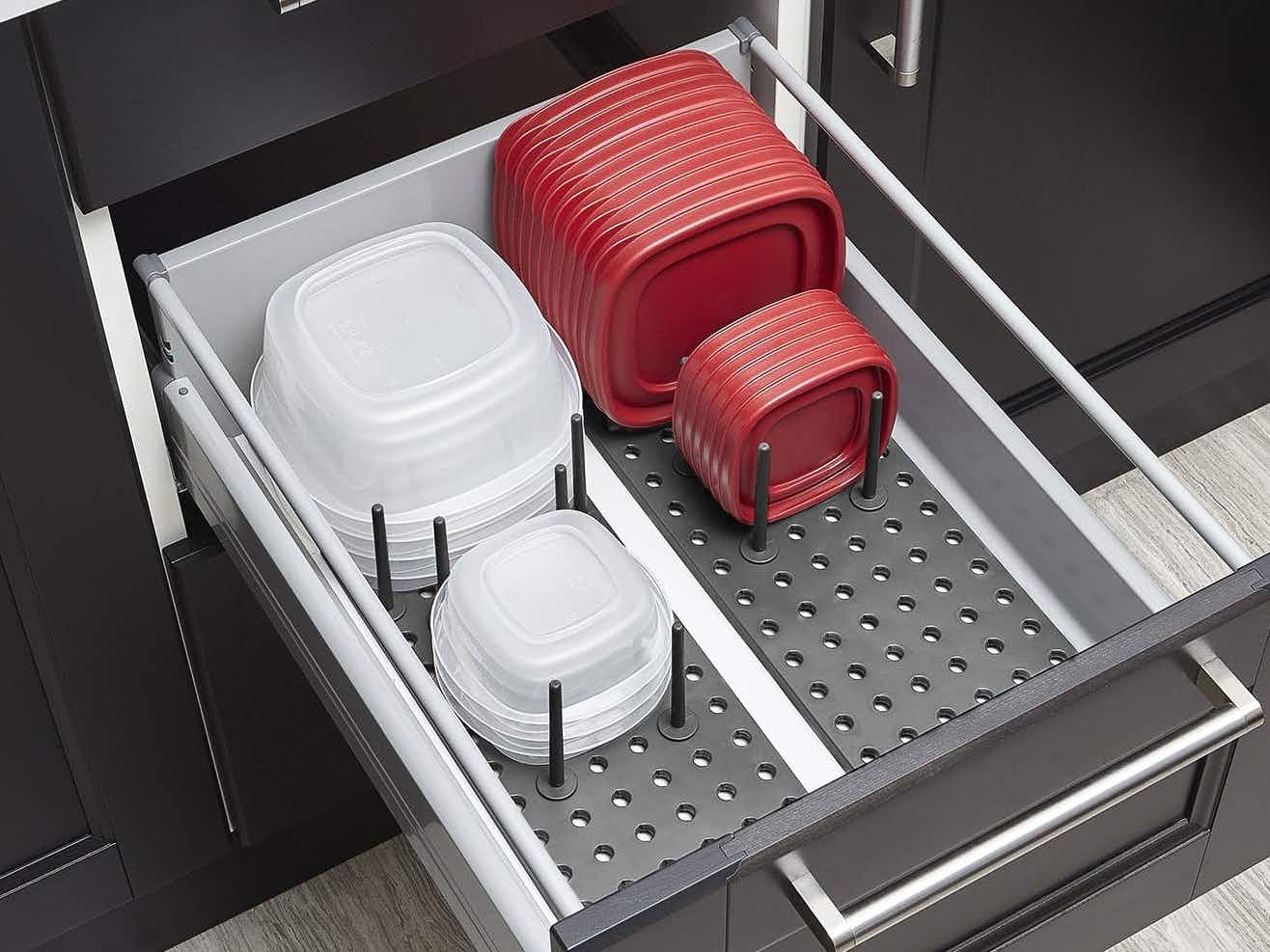 Tupperware and lids organized in a drawer using pegboards