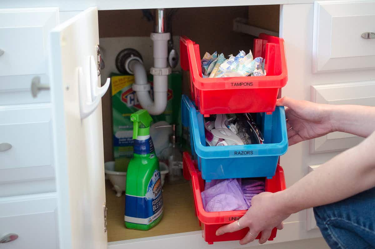 Use dollar store stacking bins under bathroom and kitchen sinks.