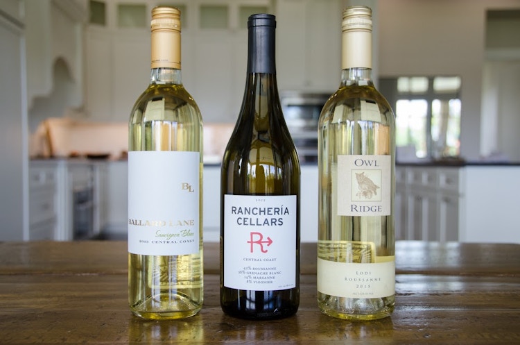 three bottles of wine sitting on a table 
