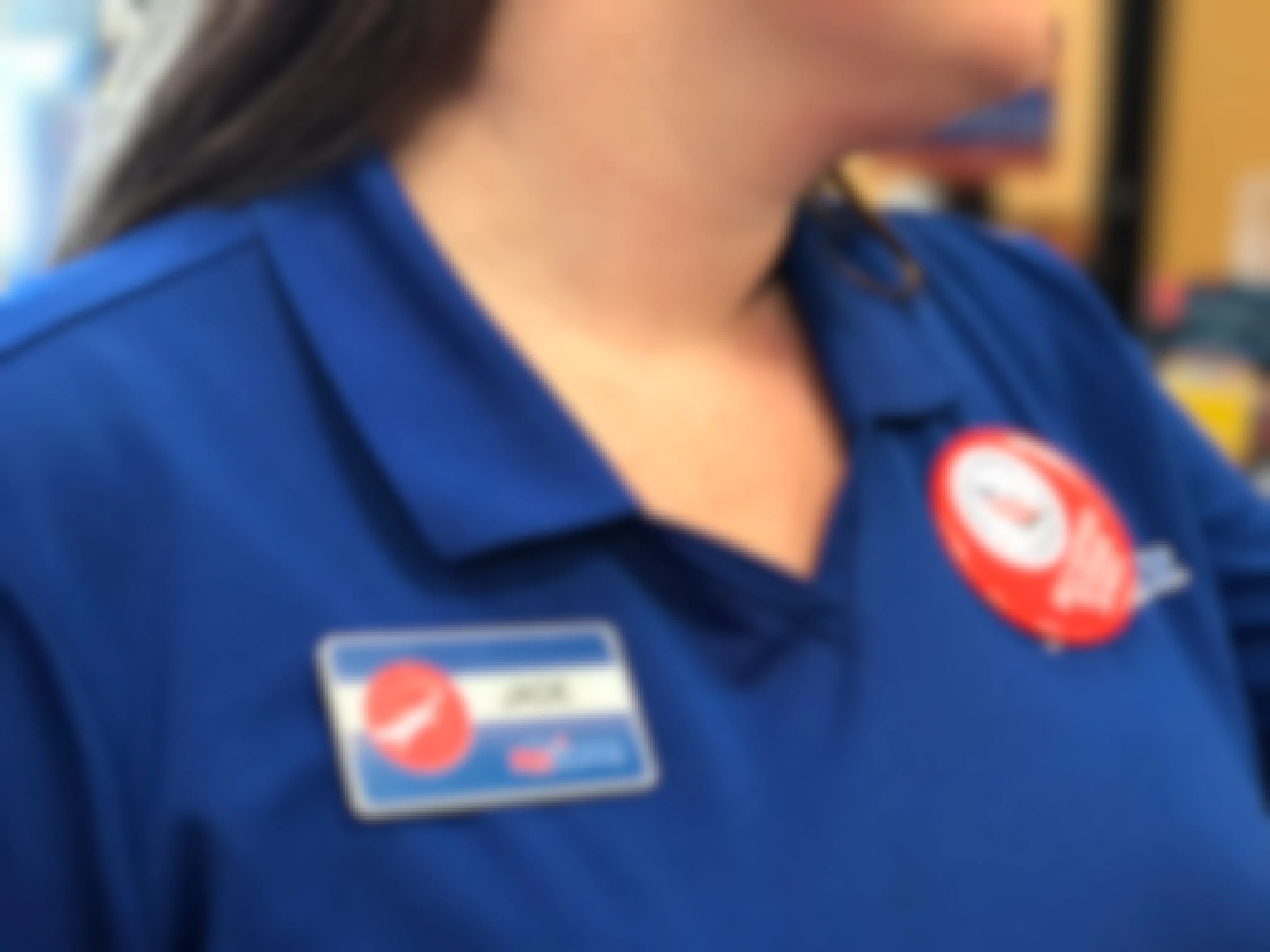 A close-up of a PetSmart employee, showing her name tag that reads, "Jade".