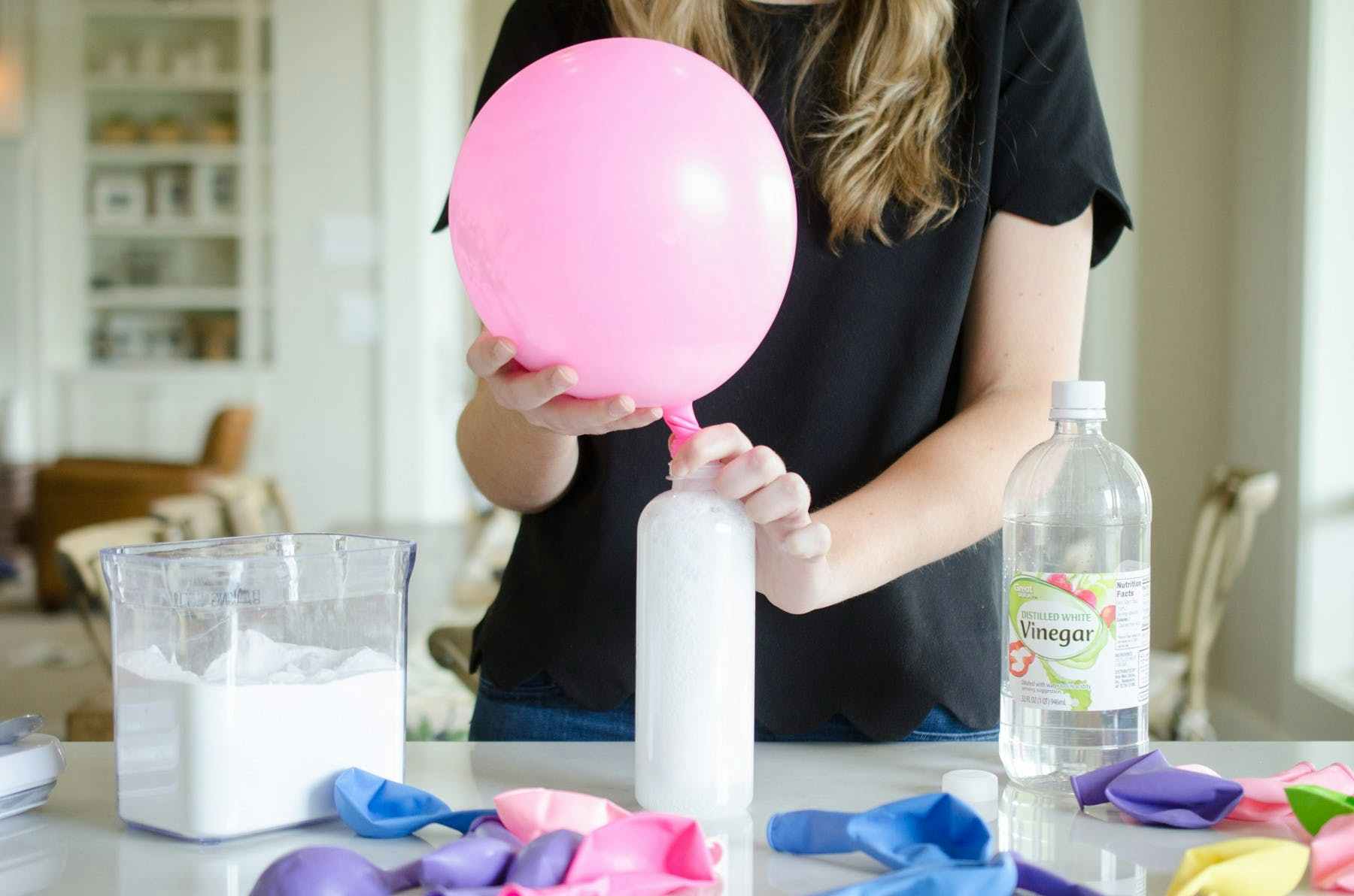 A balloon being inflated from the chemical reaction of vinegar and baking soda