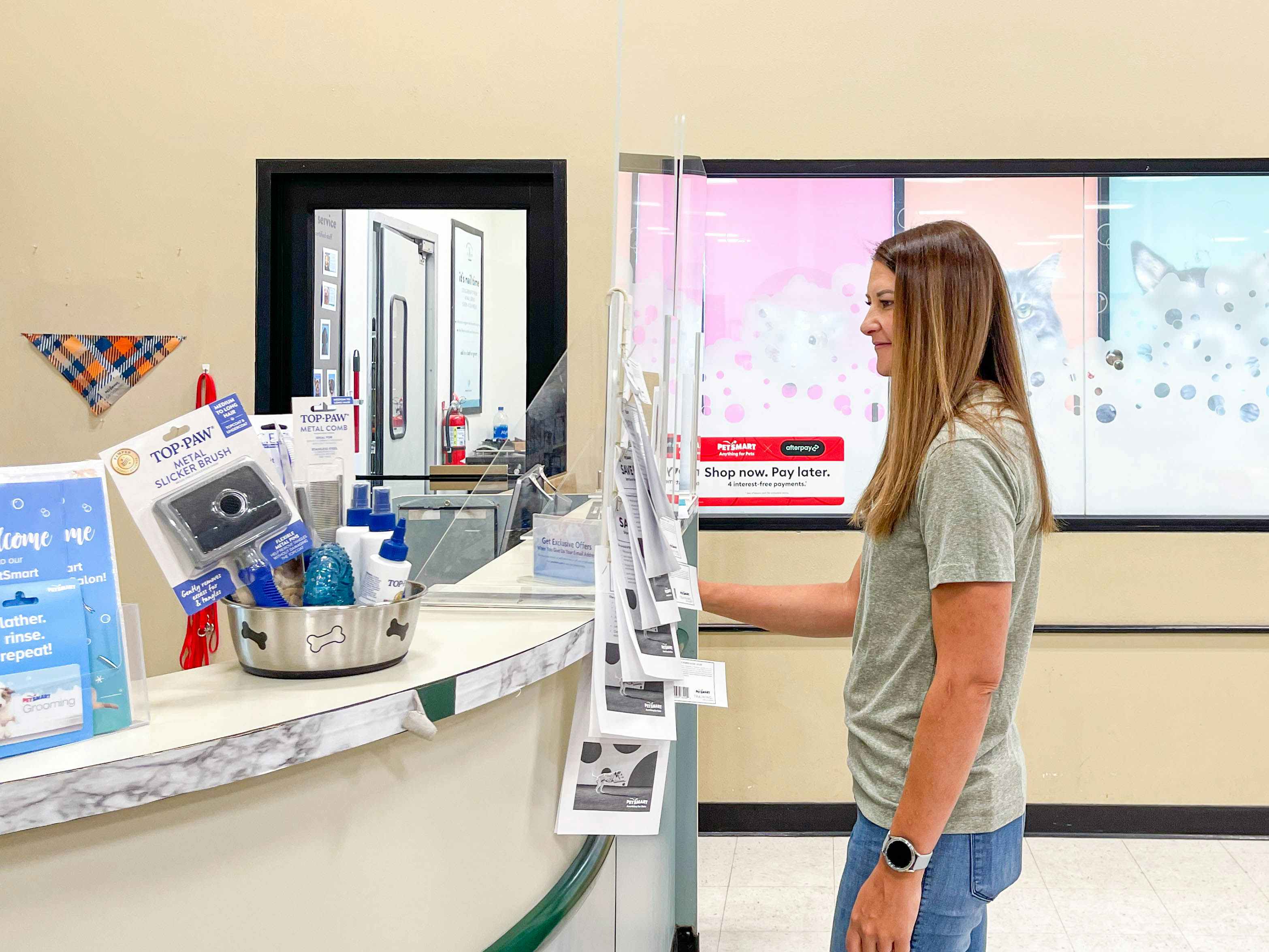 woman standing at the counter for petsmart grooming clinic