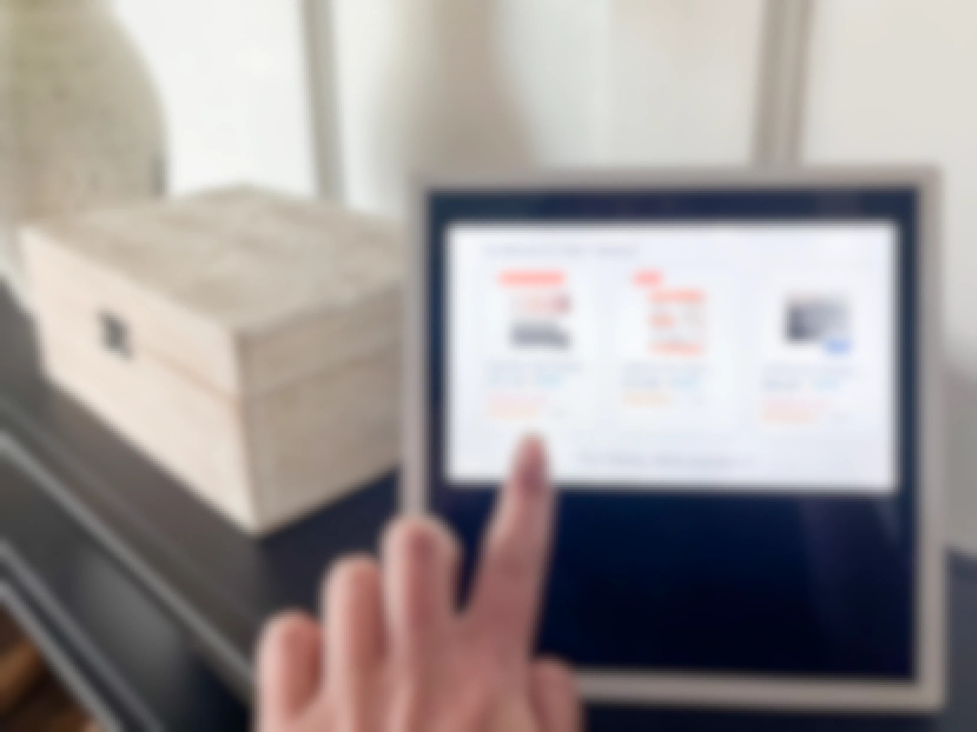 a woman's hand pointing to an amazon prime day deal featured on their echo show