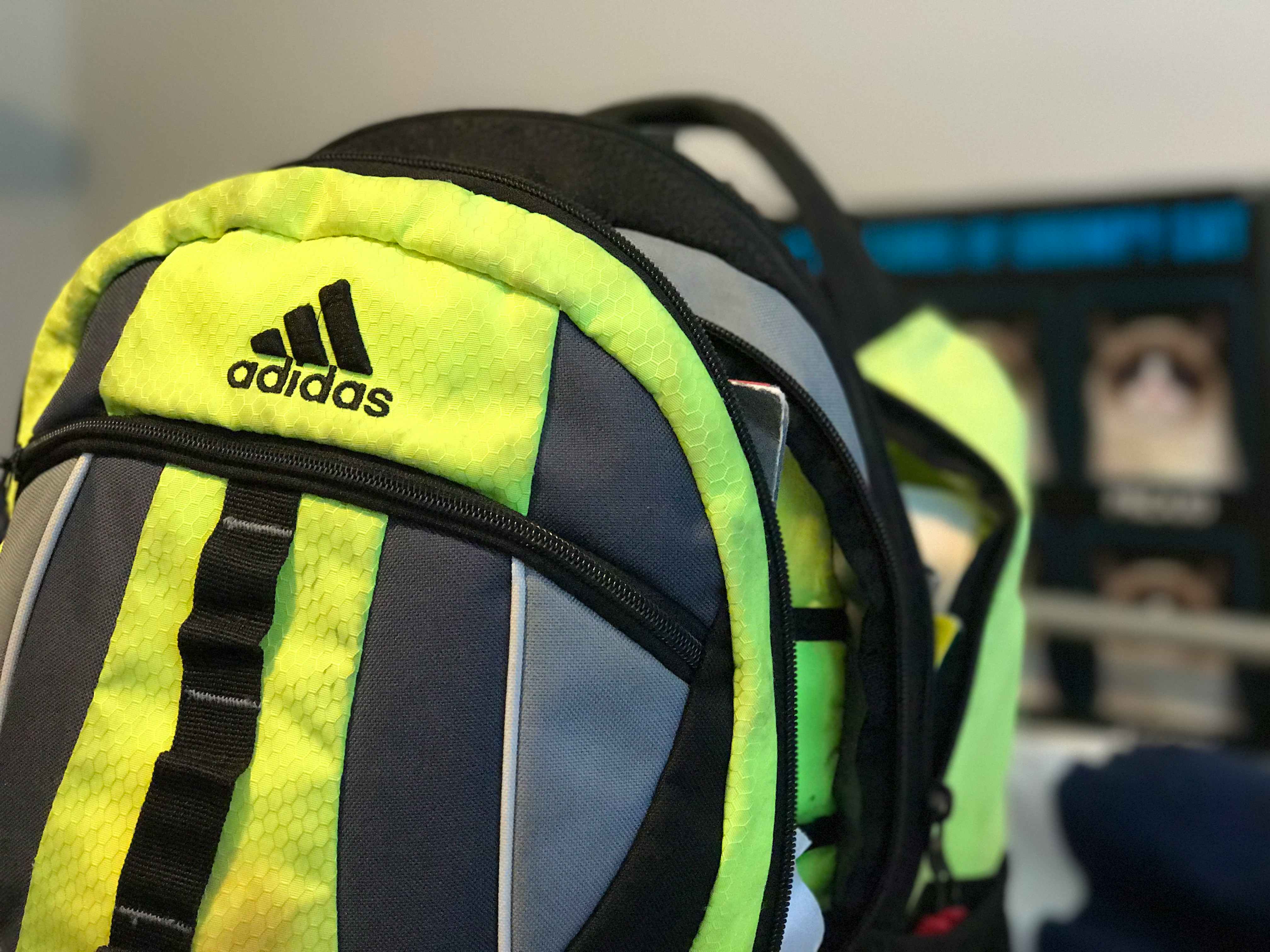 An unzipped Adidas backpack 