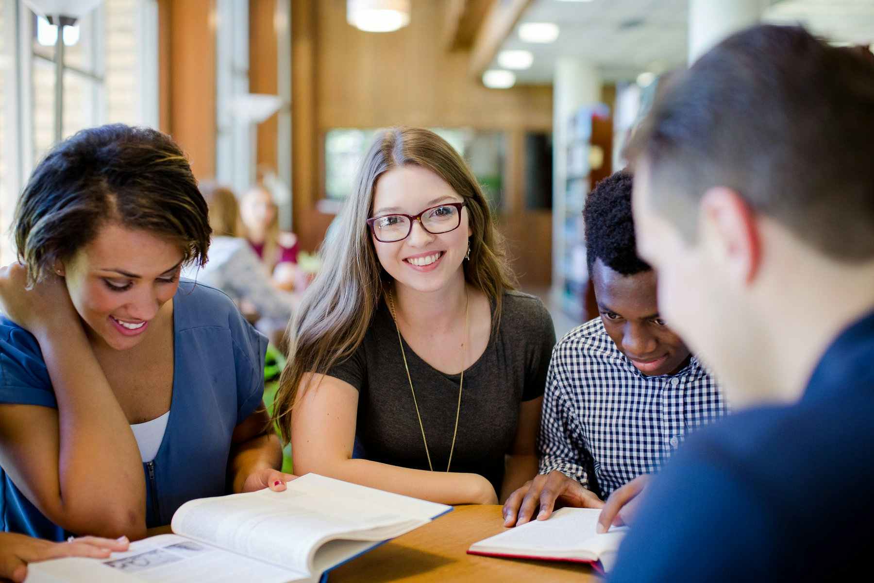 Students at College of the Ozarks studying at a table in a library.