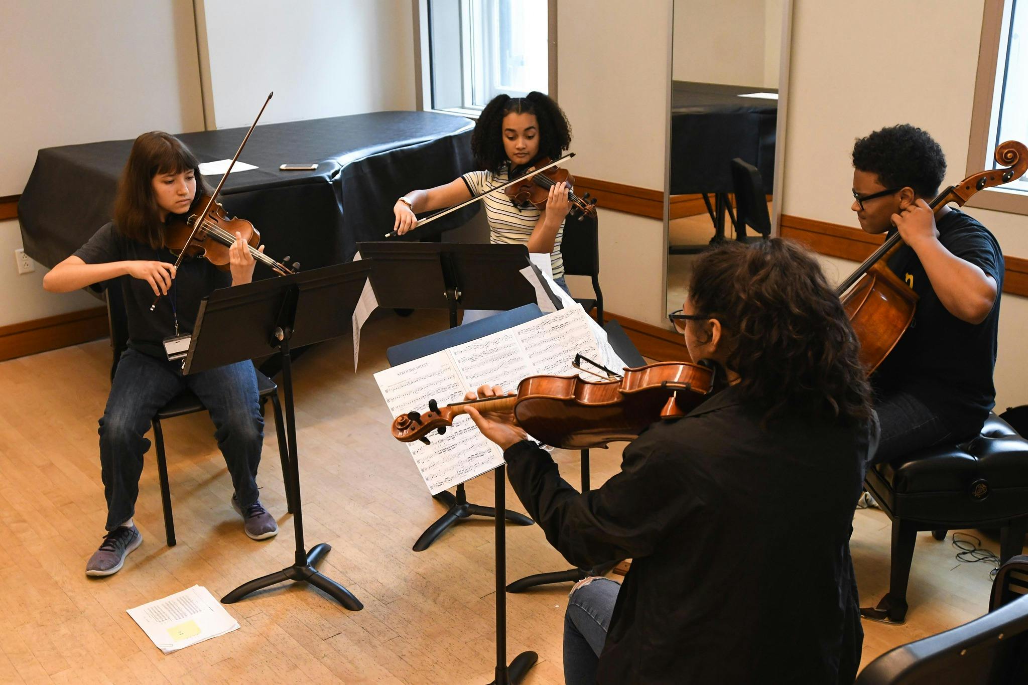 Students at Curtis Institute of Music playing instruments in a classroom.