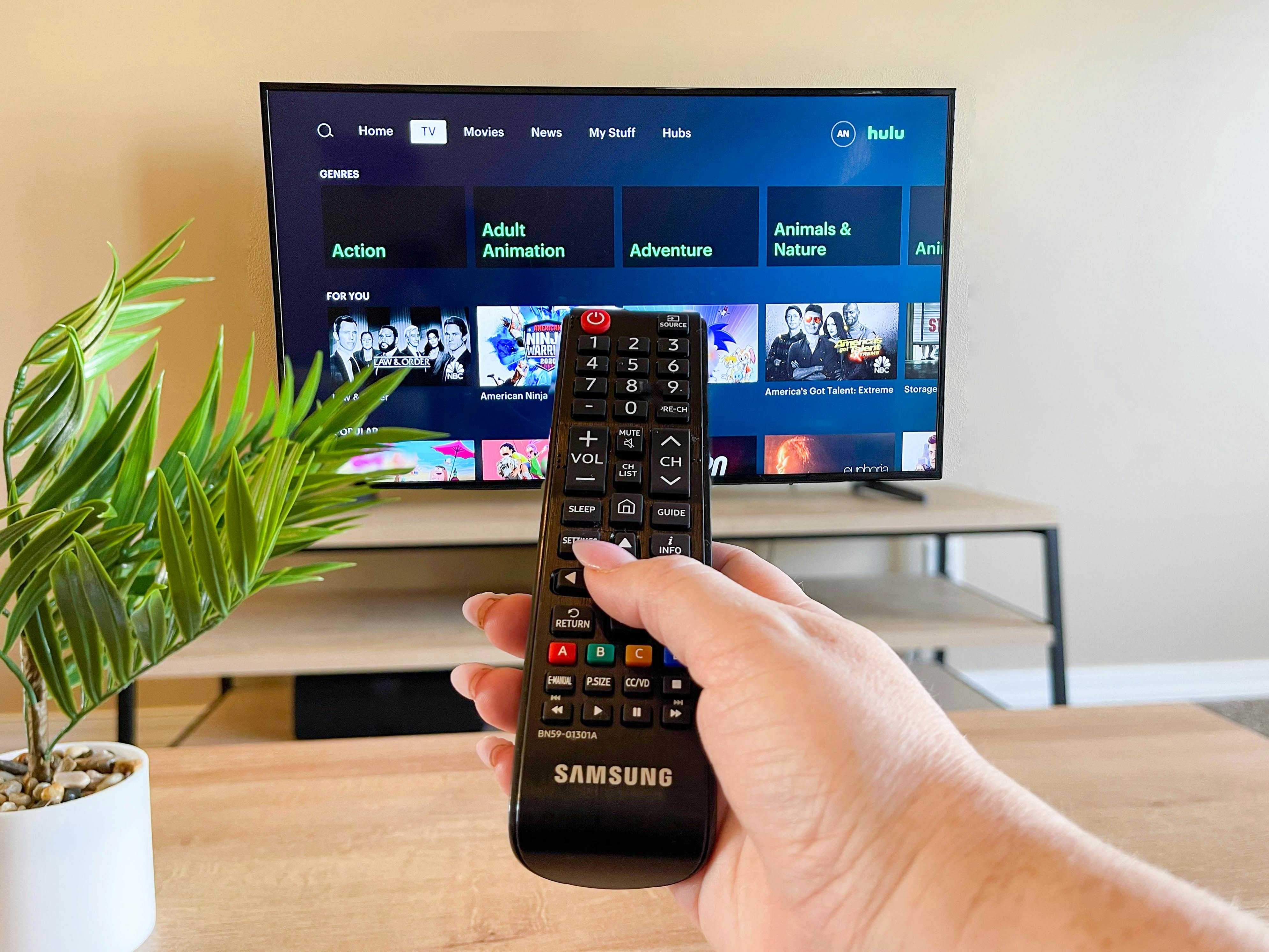 hand pointing remote at tv watching hulu