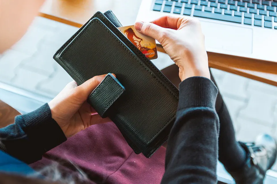 someone taking credit card out of wallet
