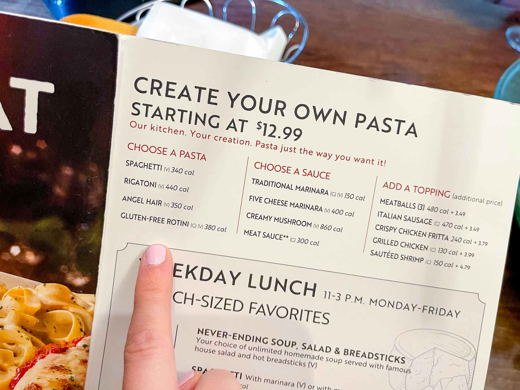 Someone pointing to the Gluten Free option on the Create Your Own Pasta section of the Olive Garden menu