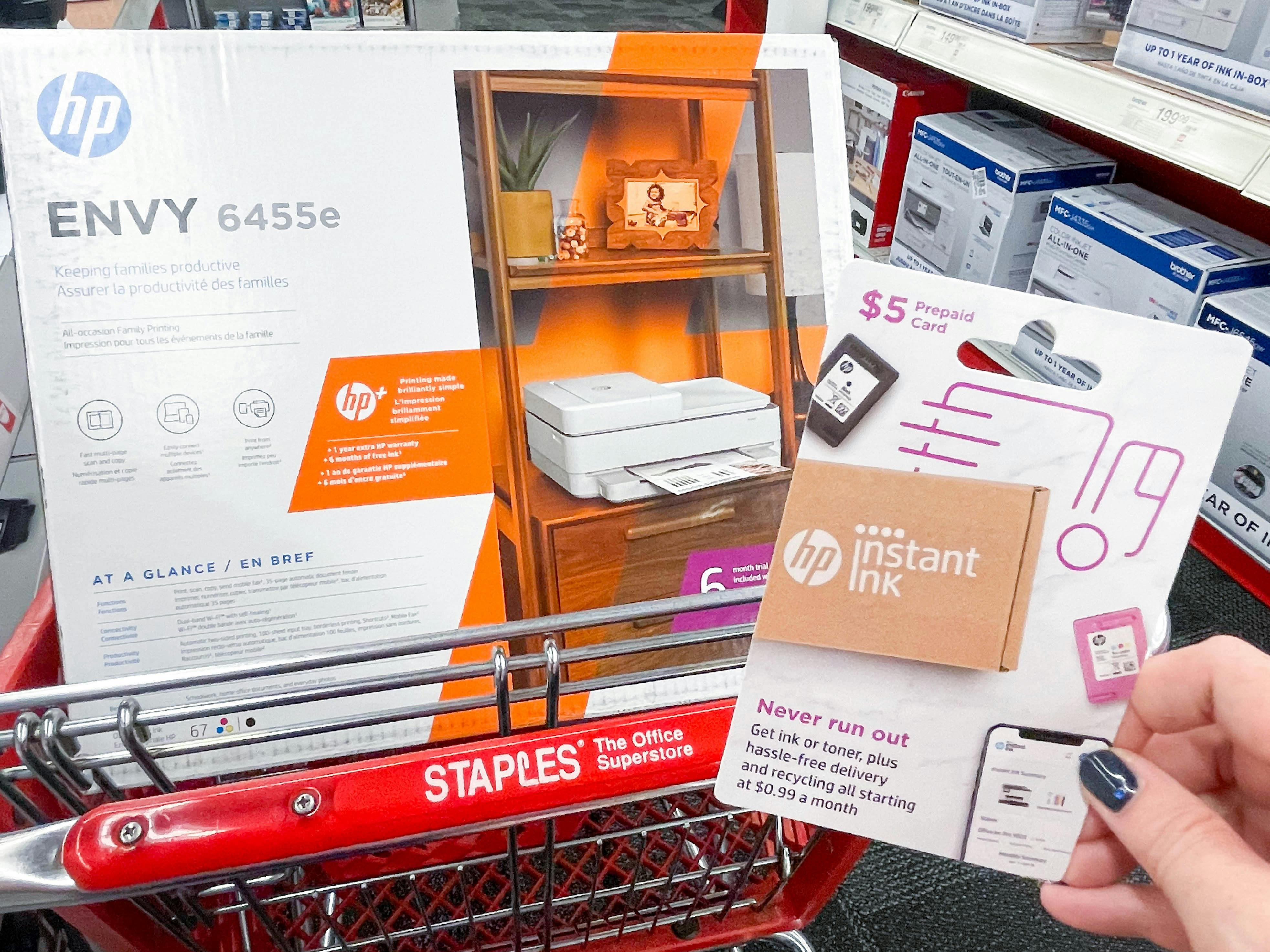 instant ink gift card being held in front of printer in cart
