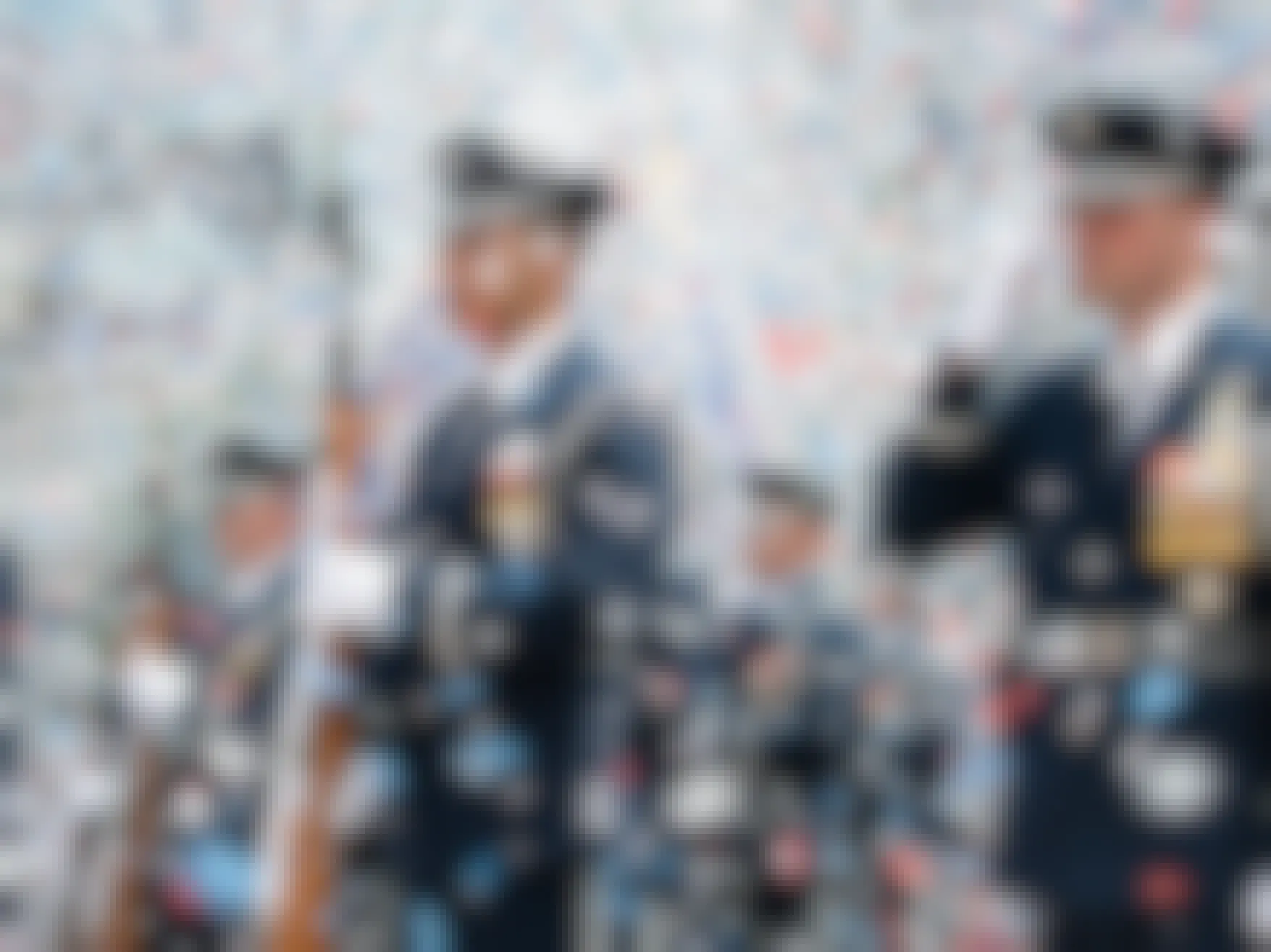 US Air Force soldiers dressed in uniform with confetti flying around them