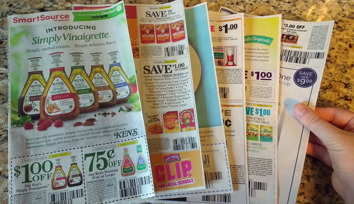 Six newspaper inserts spread out on a countertop. Insert on top is SmartSource.