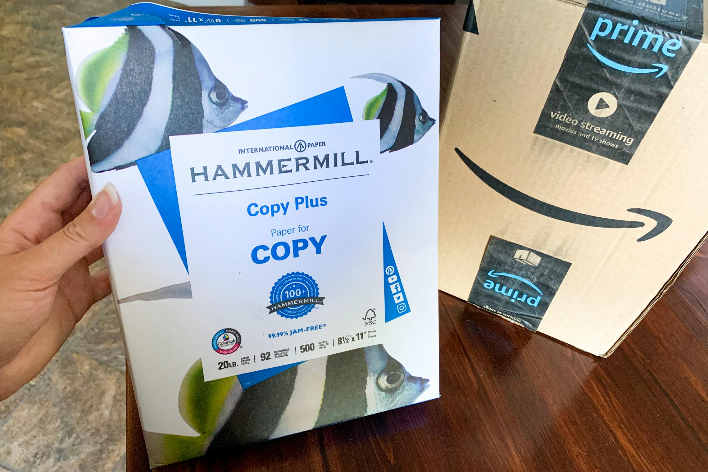 Hammermill copy paper next to an amazon box.