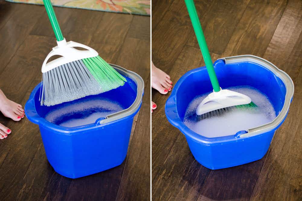broom in a bucket of warm water and dish soap.