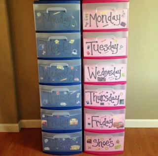 Separate daily outfits in labeled plastic storage bins.