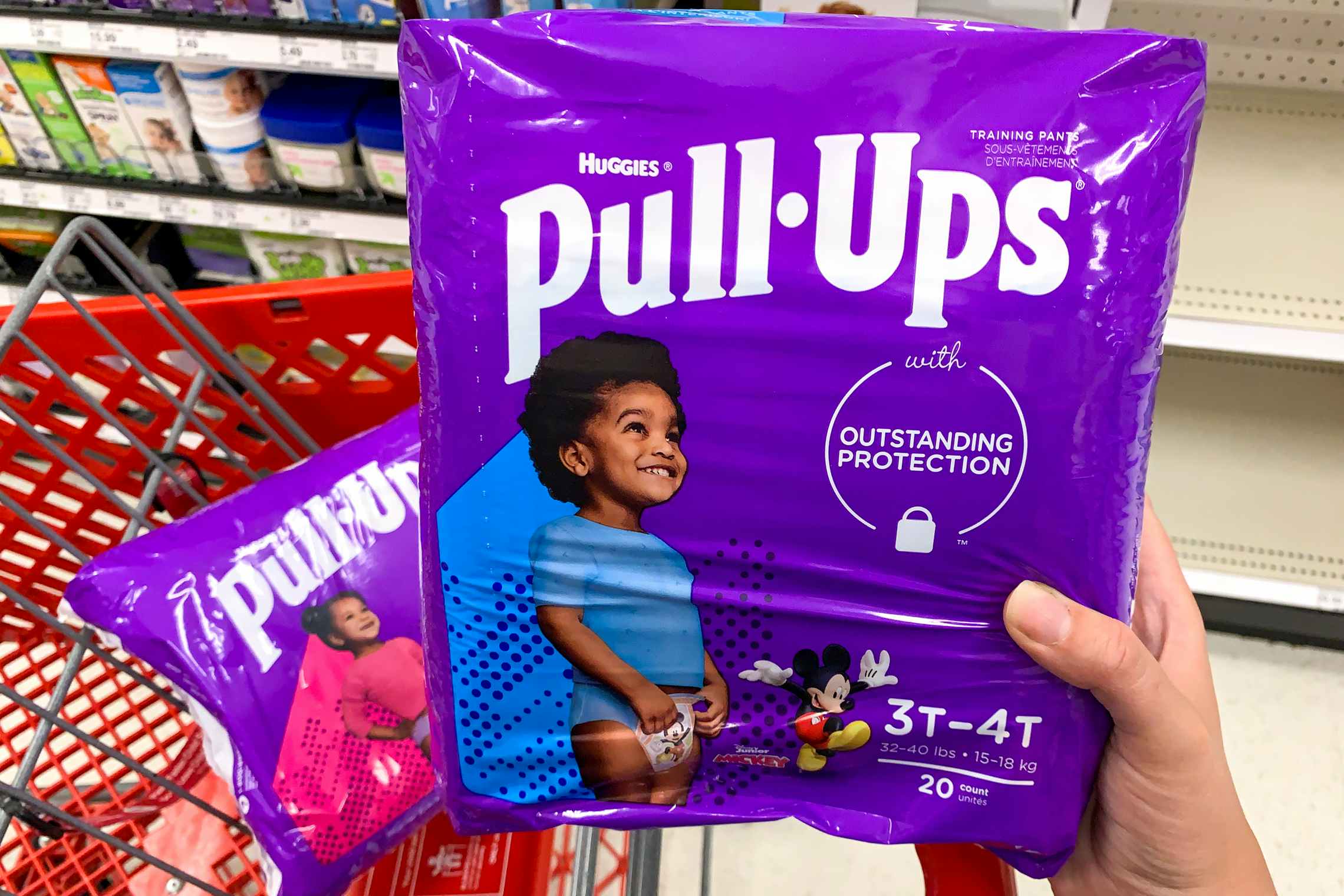 Two packs of Huggies Pull Ups training pants on a target cart.