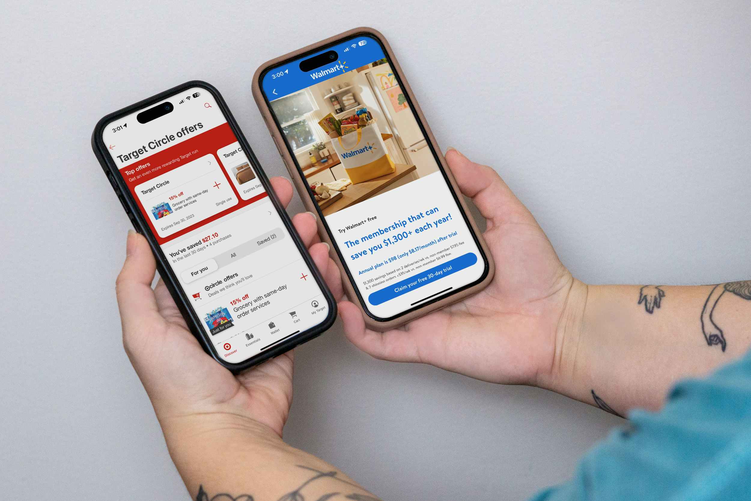 someone holding up two phones, one displaying the Walmart app and the other displaying the Target app