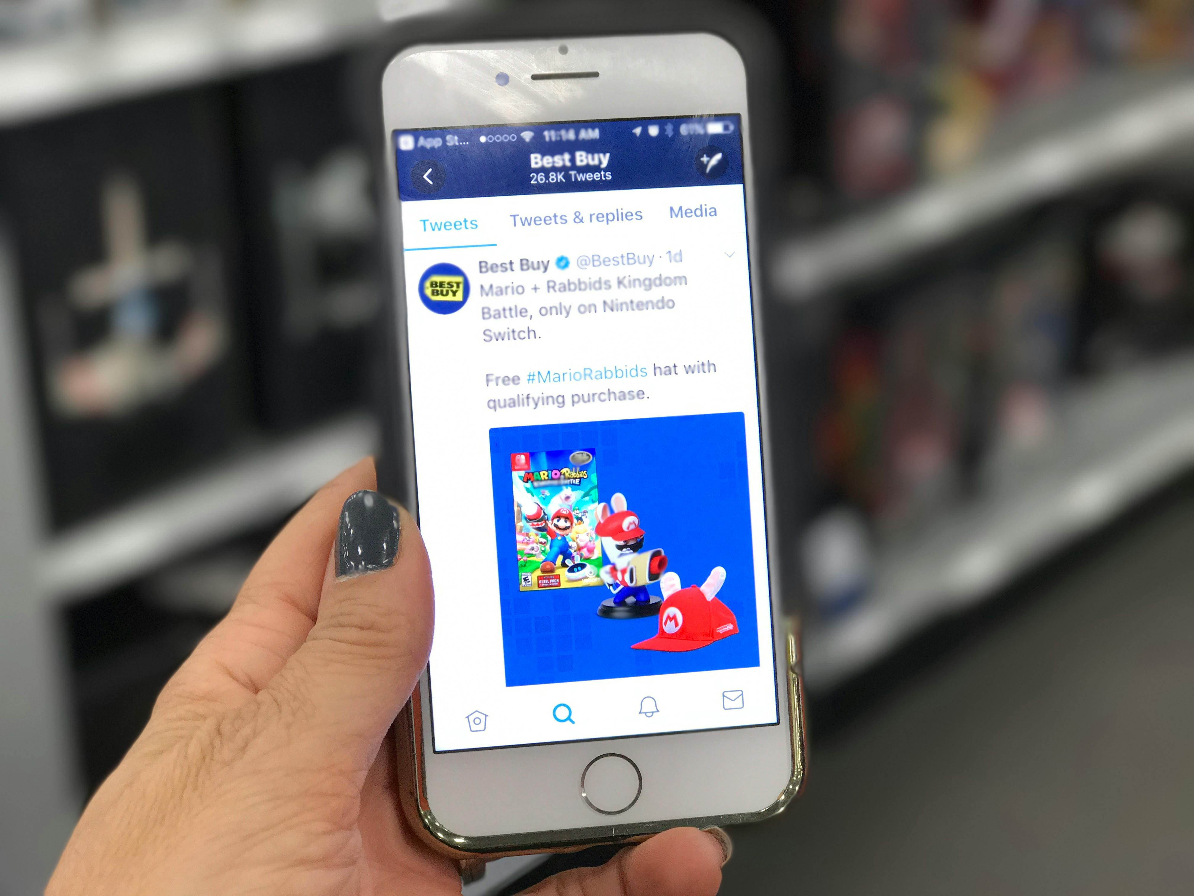hand holds phone with best buy app open to best buy deal of the day