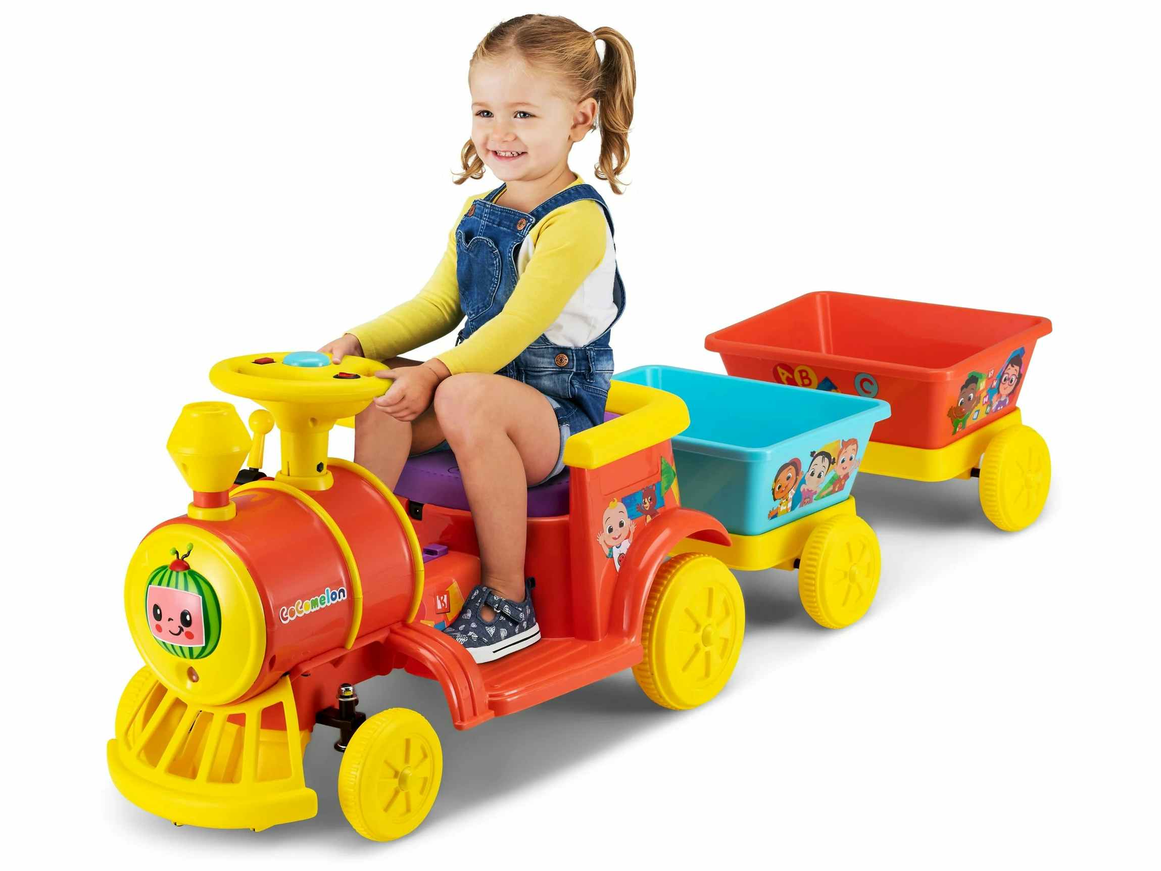 a little girl sitting on a cocomelon choo choo train ride on toy