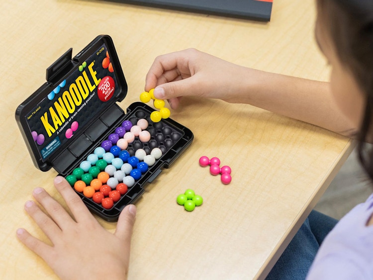 someone playing with a Kanoodle puzzle toy